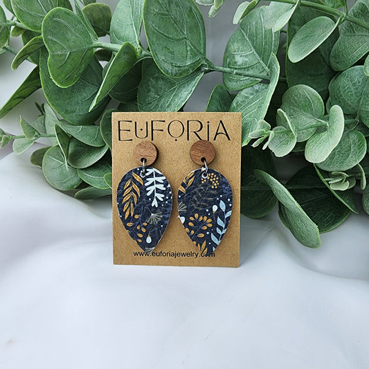 Leather teardrop earrings with round wood post. Floral print in neutral tones over a navy field..