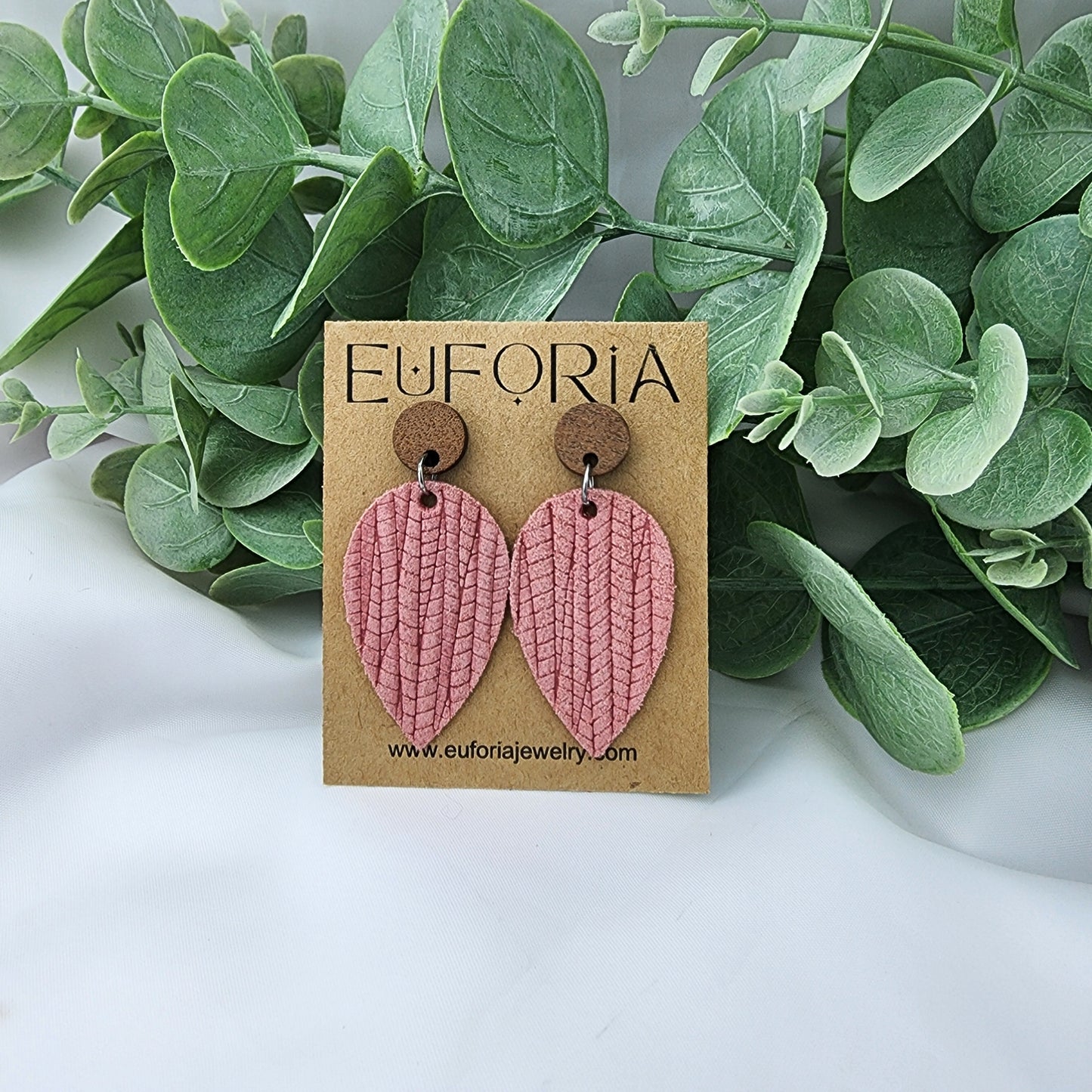 Leather teardrop earrings with round wood post. Salmon pink, woven palm leaf texture.